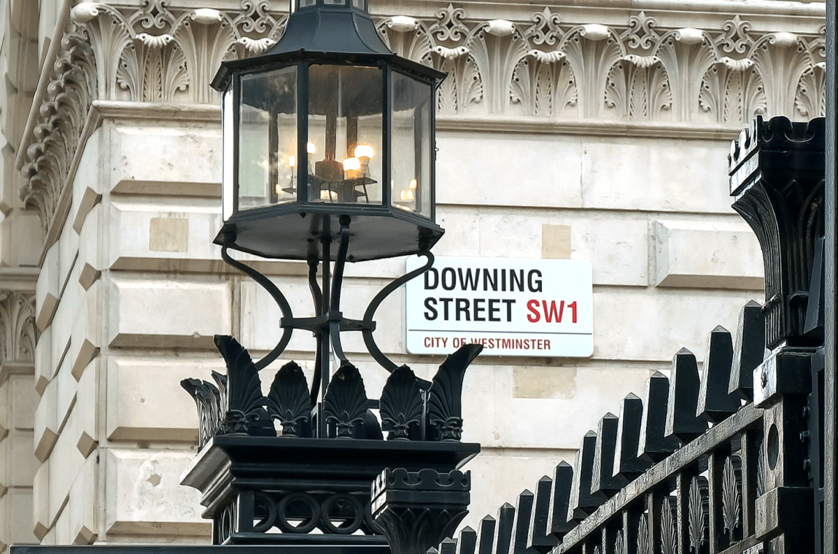 Downing Street SW1 sign on building in London.